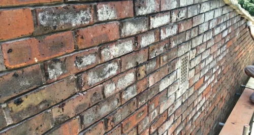 Before — stained and mismatched brickwork, Hackney