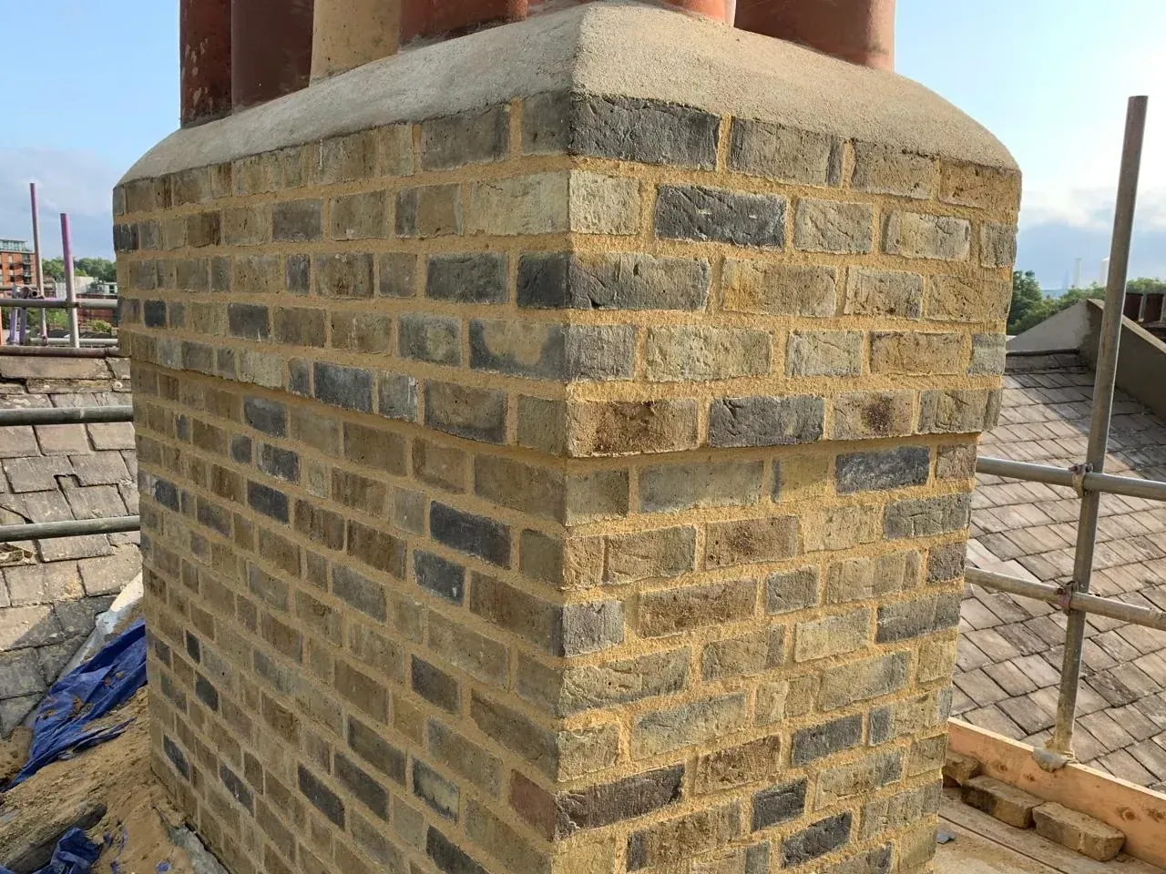 Rebuilt chimney stack in yellow stock brick with lime repointing, new pots and re-flaunching, Chelsea, SW London