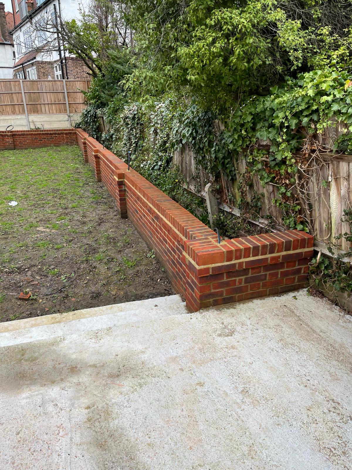 New build garden wall construction with reclaimed brick to match existing property, Finchley North London