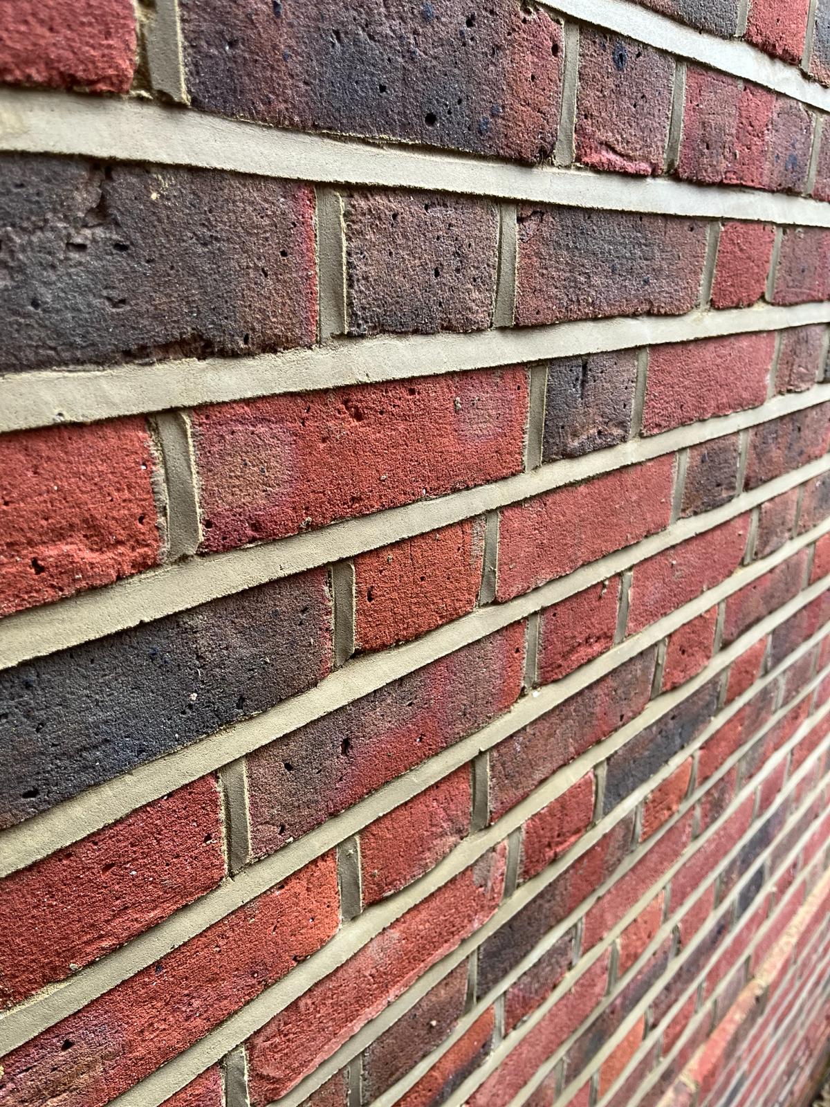 Victorian brickwork after weather-struck repointing — freshly pointed mortar joints, Barnet North London